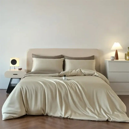 Beige satin duvet cover set with matching fitted and flat sheets featuring smooth luxurious lyocell silk texture