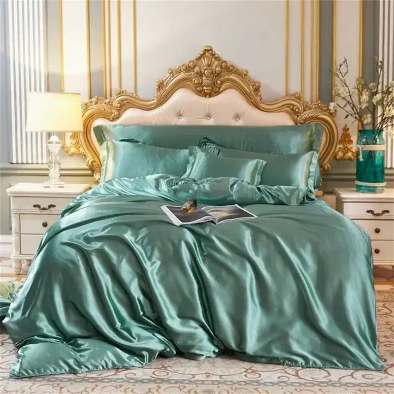 Luxurious teal satin duvet cover bedding set with glossy finish and matching pillowcases on gold-framed bed by DecorBites
