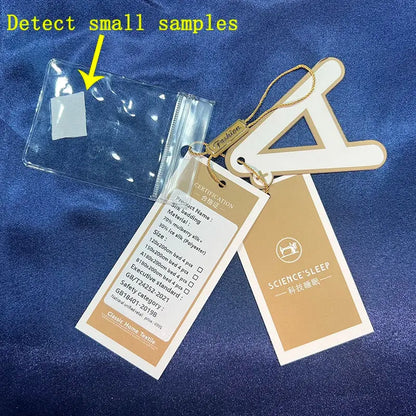 Clear plastic sample pouch with white label attached to beige and gold science sleep tags on luxurious mulberry silk duvet cover set