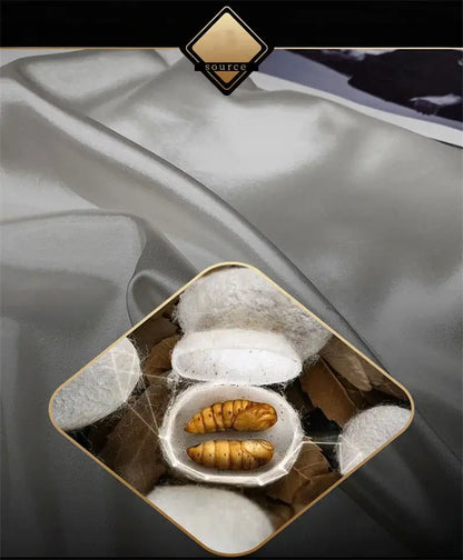 A white ceramic bowl with golden-brown silkworms and silk cocoons representing mulberry silk for the bedding set