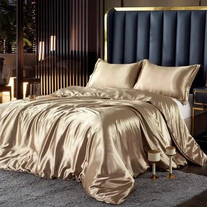 Glossy champagne-colored silk duvet cover and matching pcs duvet cover elegantly draped over width bed for couples