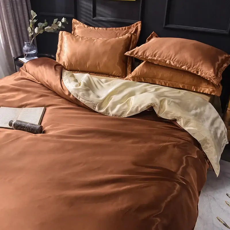 Decorbites™ luxurious silk bedding set featuring a copper-toned satin duvet cover and bed sheet with cream inner lining