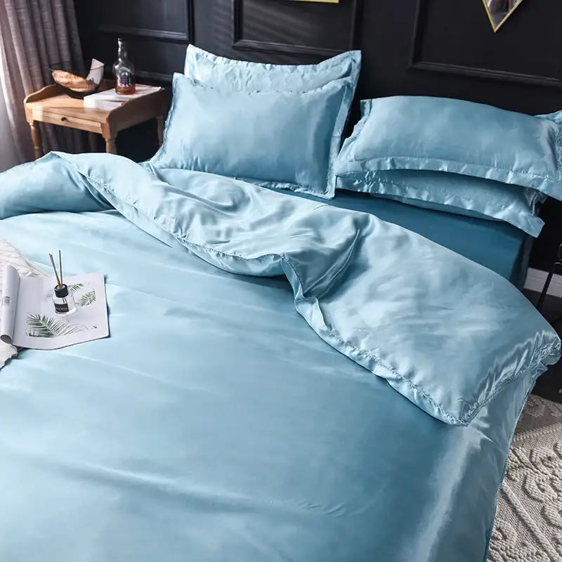 Light blue silk bedding set by DecorBites with smooth satin bed sheet and matching duvet cover in various sizes