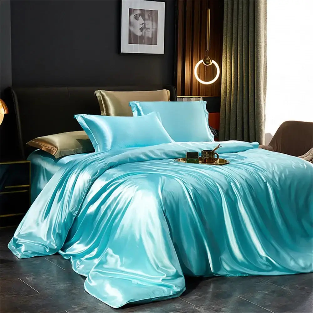 Turquoise satin duvet cover and matching pillows with gold-trimmed accent pillow in decorbites luxurious solid silk pcs duvet cover set