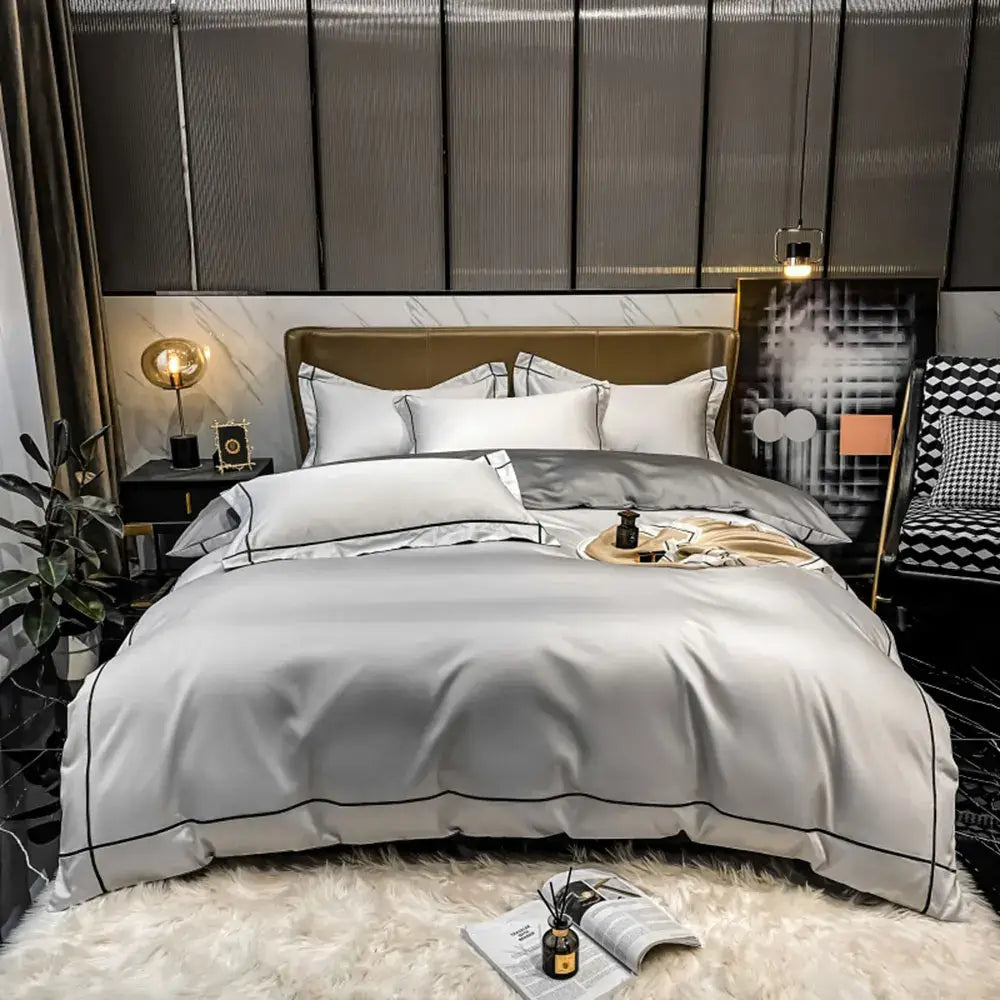 Luxury silver satin duvet cover bedding set with black piping and matching pillowcases made of egyptian cotton