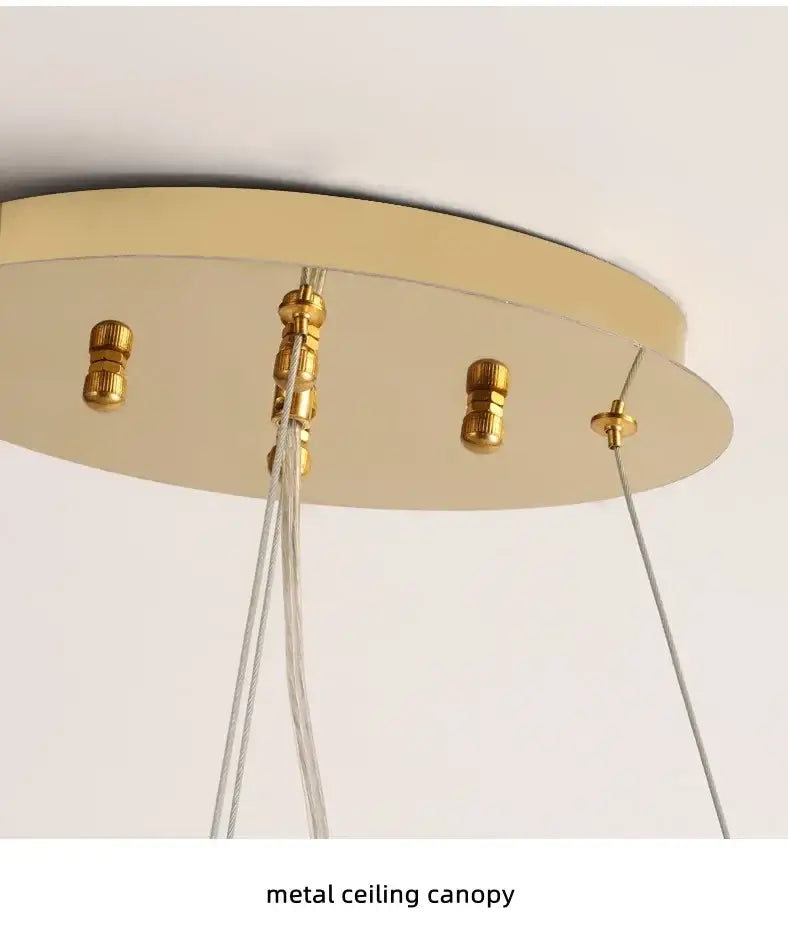 Gold-toned metal ceiling canopy with circular design and brass fixtures for DecorBites luxury crystal chandelier living room use