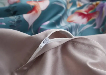 Beige satin pillowcase with white zipper closure from DecorBites™ luxury egyptian cotton duvet cover set against teal floral fabric background