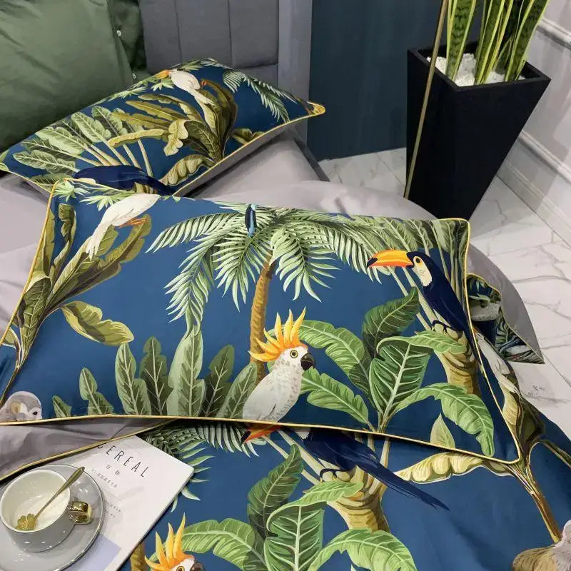 Blue tropical-themed pillow sham with vibrant foliage and parrots accented with gold trim from DecorBites Egyptian cotton bedding set