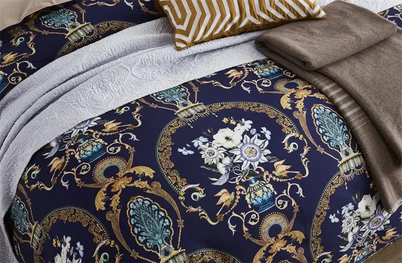 The navy blue duvet cover with gold and teal floral motifs is part of the DecorBites™ luxury egyptian cotton bedding set