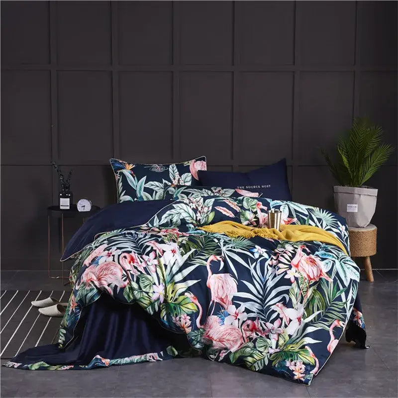 Navy blue duvet cover and pillowcases set with vibrant pink flamingos and green foliage in egyptian cotton by DecorBites™