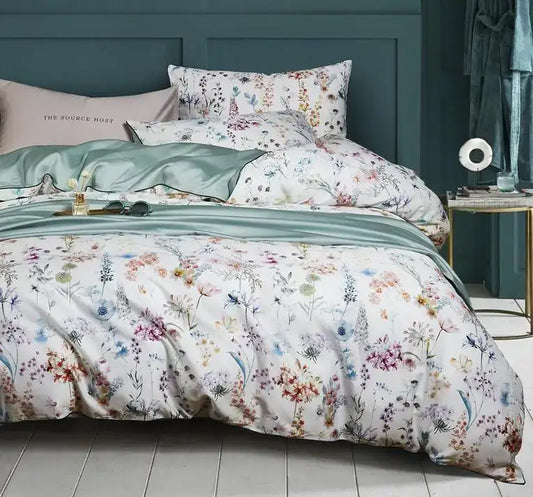A soft white egyptian cotton duvet cover and matching pillowcases with pastel flamingo leaf floral pattern by DecorBites