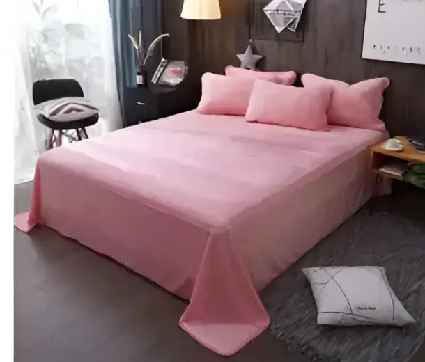 Pink satin egyptian cotton duvet cover with matching pillowcases draped over a neatly made bed by DecorBites luxury