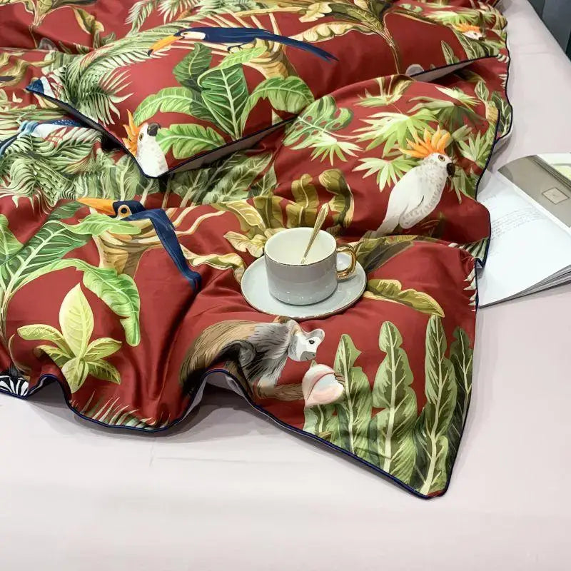Red tropical-themed duvet cover with vibrant green leaves and birds in egyptian cotton by decorbites luxury set