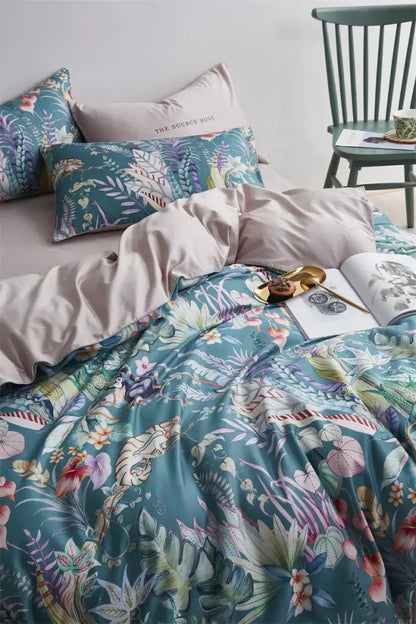 Teal satin duvet cover with vibrant tropical botanical print in pink purple green on luxury egyptian cotton bedding set
