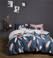 Navy blue feather-patterned duvet cover set with coordinating pillowcases made of egyptian cotton by decorbites luxury collection