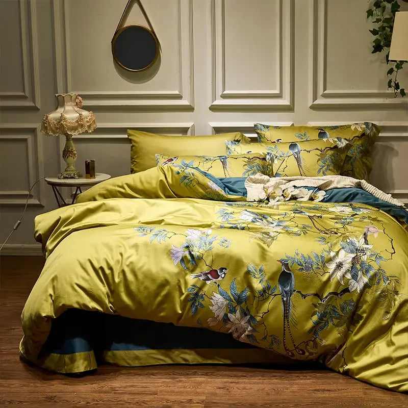 Vibrant yellow satin duvet cover set with bird and floral embroidery in blue white and pink made of egyptian cotton