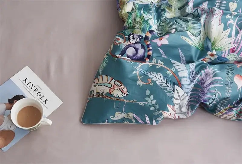 Teal duvet cover with vibrant jungle print featuring monkeys and chameleons part of decorbites luxury egyptian cotton bedding set