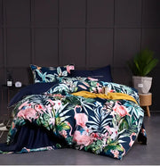 DecorBites luxury Egyptian cotton duvet cover set in navy blue with pink flamingos and green tropical leaf pillowcases