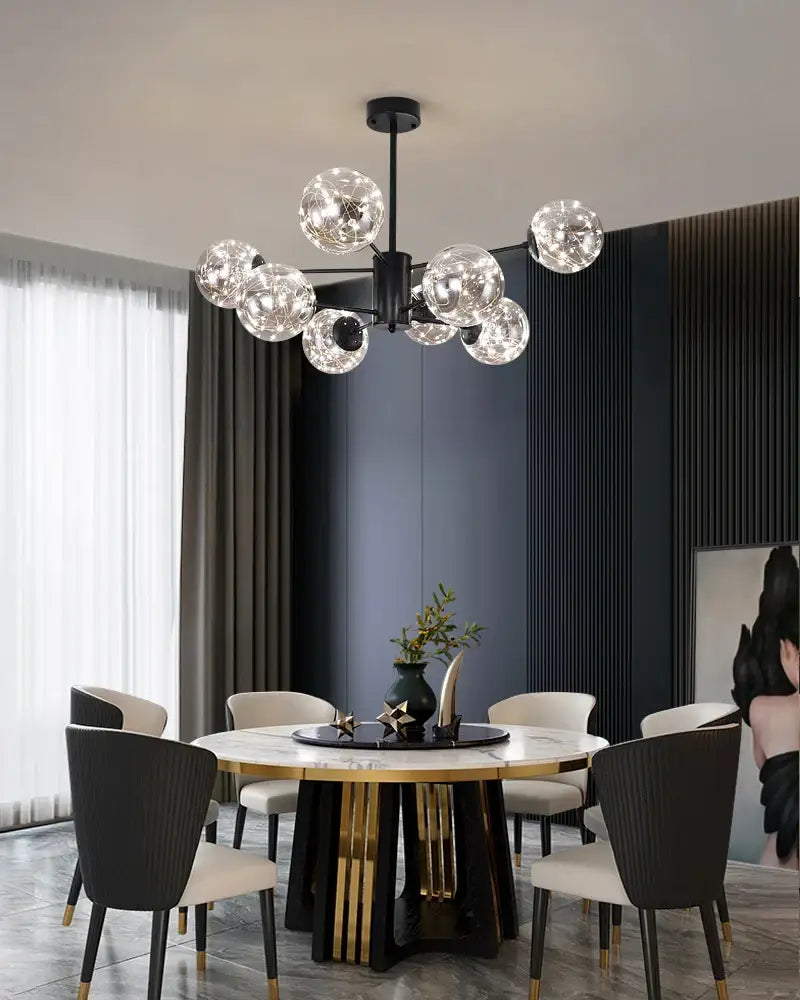 Modern black metal chandelier with multiple clear glass ball bulbs emitting warm light, dimmable with remote control