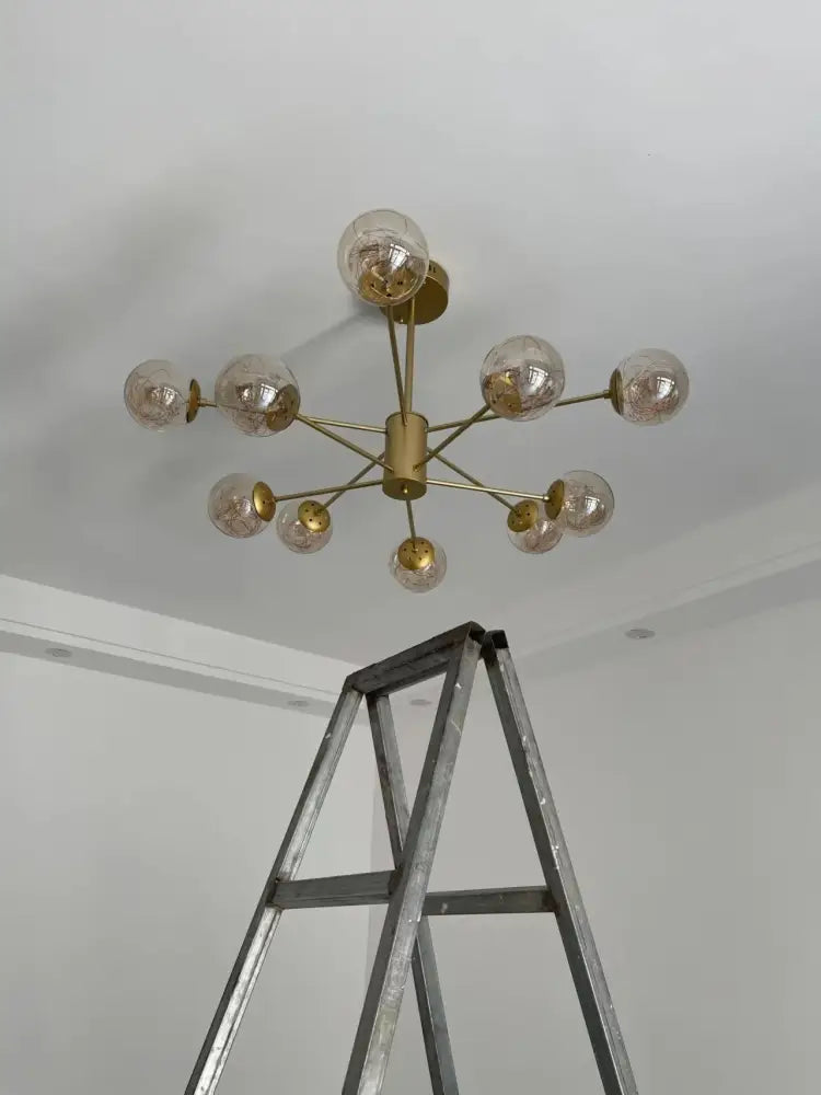 A modern brass DecorBites™ luxury glass ball chandelier with warm light and remote control dimmable glass globes