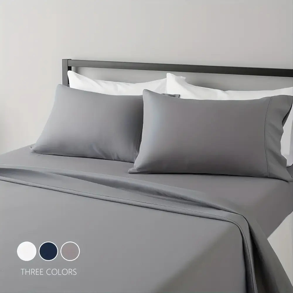Gray satin pillowcases and matching sheet set from DecorBites™ luxury bed collection offering hotel luxury and breathable comfort
