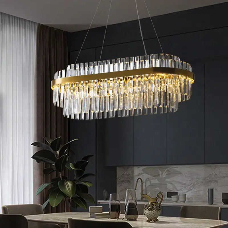 Gold-toned oval luxury led crystal chandelier with cascading clear crystal prisms for elegant home decor by decorbites