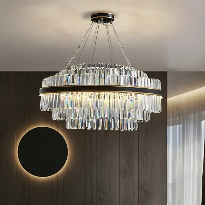 A modern two-tiered DecorBites™ luxury led crystal chandelier with black and gold frame and cascading clear crystals