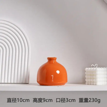 DecorBites™ luxury modern ceramic vase in glossy orange with rounded body and narrow neck for elegant decor