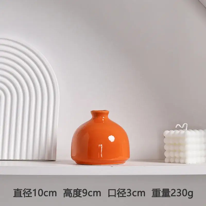 DecorBites™ luxury modern ceramic vase in glossy orange with rounded body and narrow neck for elegant decor