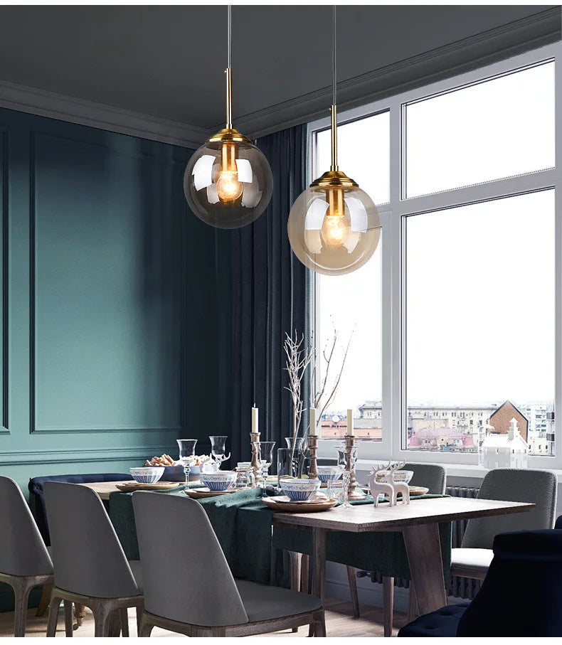 Two hanging globe pendant lights with brass-finished fixtures and glass shades in decorbites luxury nordic led chandelier for dining room