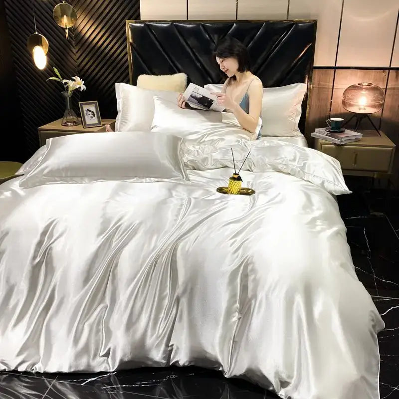 Shiny silver satin decorbites luxury silk bedding set with plush black headboard includes duvet cover and pillowcases