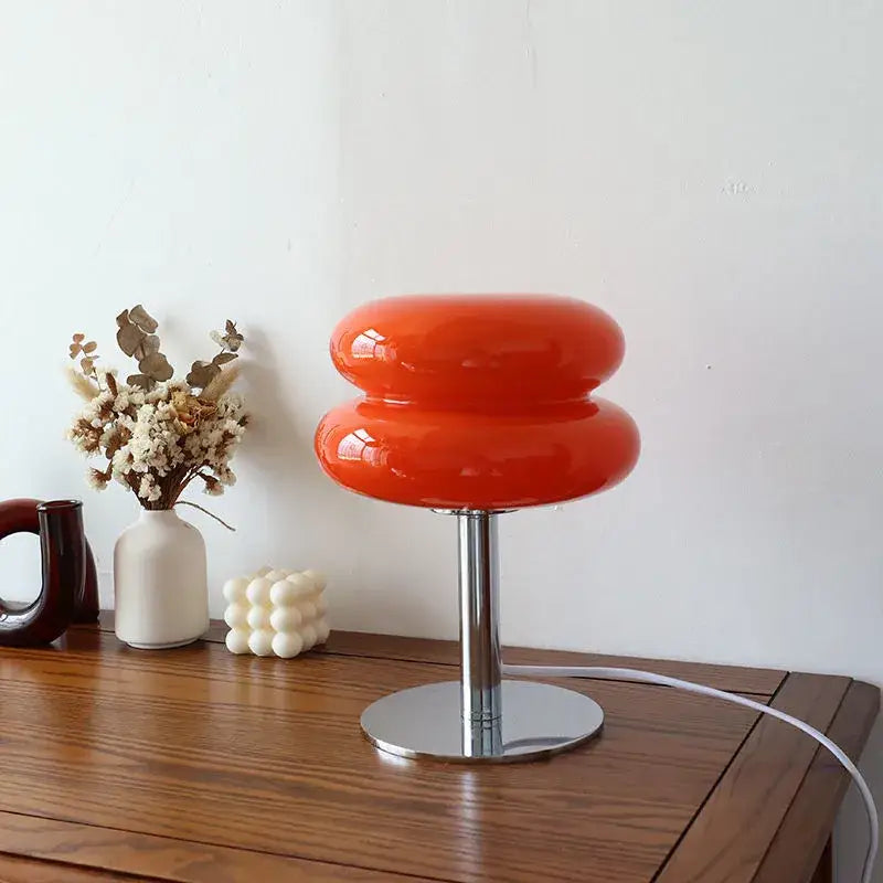 Vibrant orange glossy glass macaron lamp with sleek chrome base by italian designer italian designer table lamp