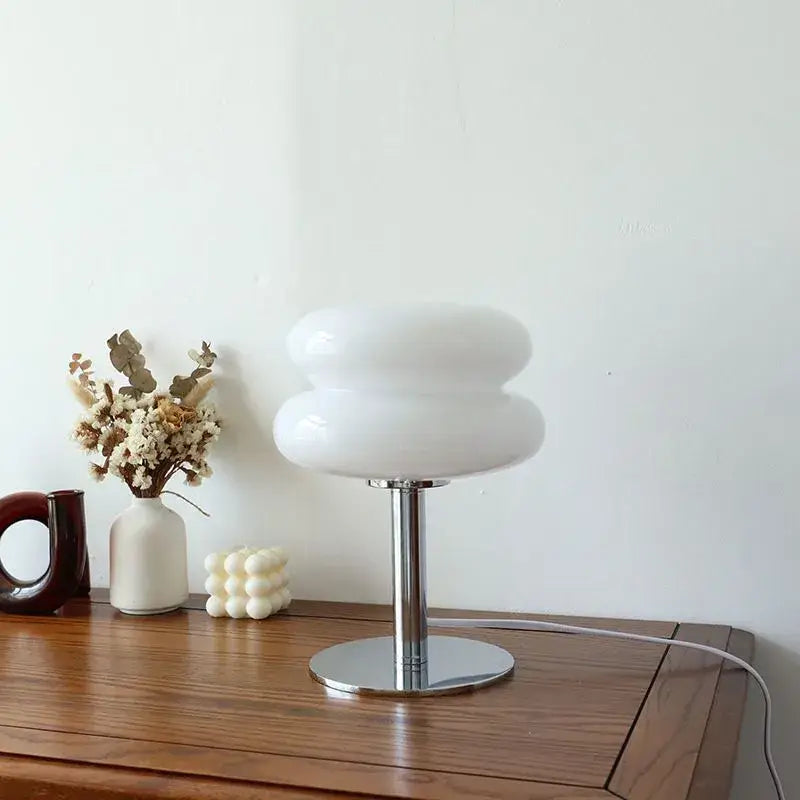 White cloud-shaped glass macaron lamp with sleek chrome base by italian designer for elegant table decor