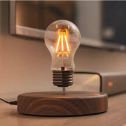 A decorbites magnetic levitation lamp featuring a floating vintage-style incandescent bulb with warm filaments on a dark wood base