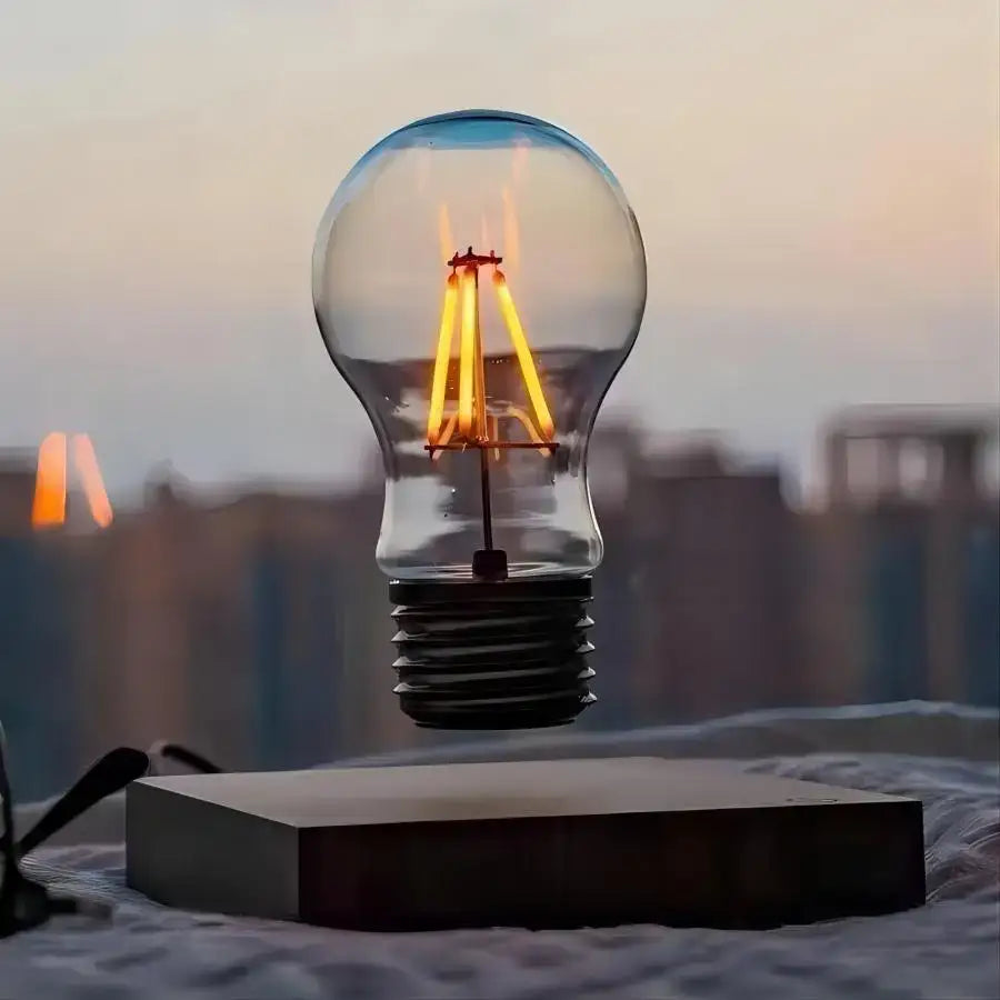 Floating transparent glass edison bulb with glowing filament and black base in decorbites magnetic levitation lamp