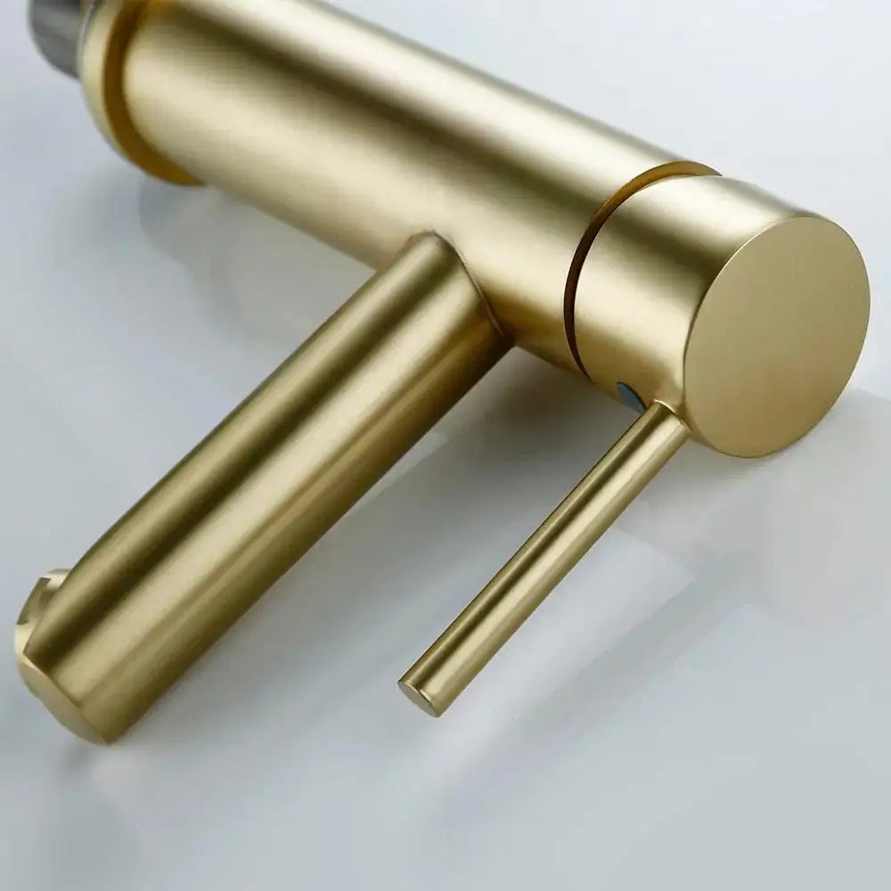 Modern brushed gold deck mounted bathroom faucet with sleek cylindrical handles from DecorBites Malena collection