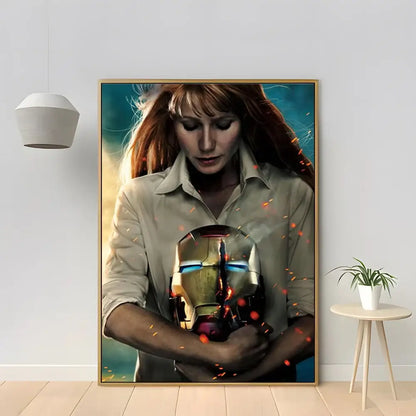 A framed canvas print from decorbites™ featuring a woman holding a marvel iron man helmet with glowing blue eyes for home decor
