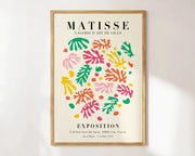 A framed decorbites™ matisse floral art poster featuring vibrant abstract flowers in pink green orange and yellow on cream