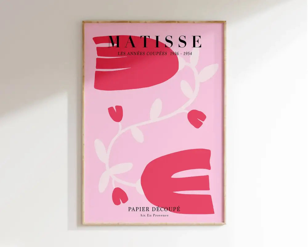 A framed pink paper cut art print with bold red and white abstract shapes featuring the text matisse for flower market decor