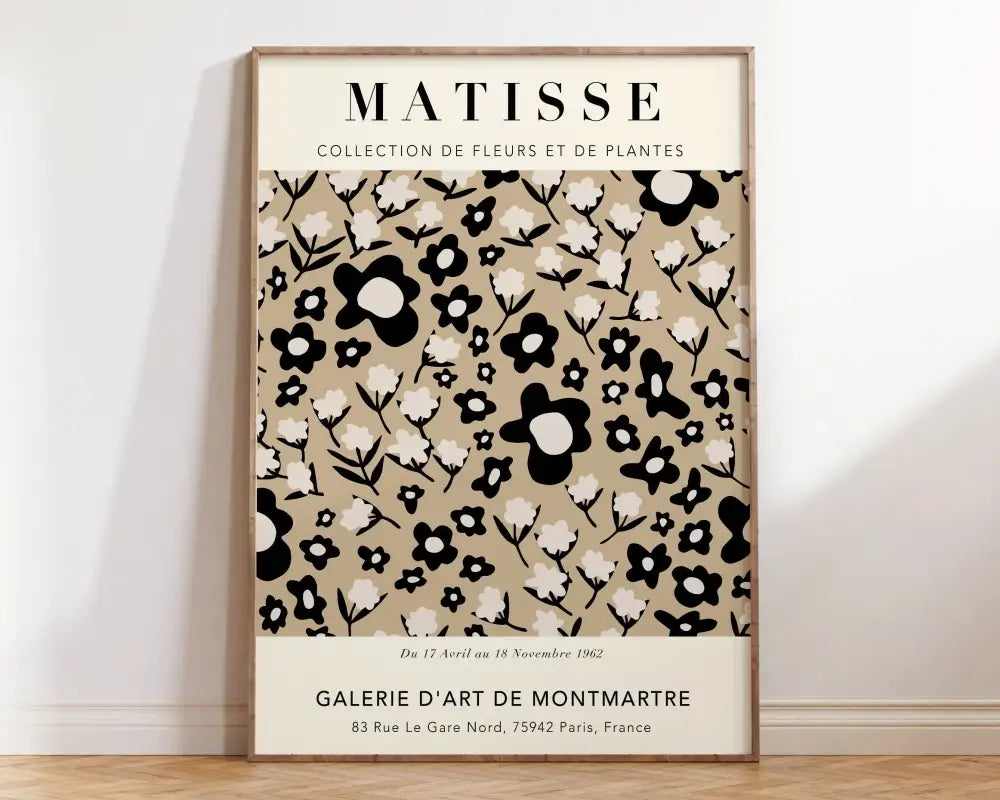 A framed decorbites matisse floral print featuring a minimalist black and white floral pattern on beige canvas