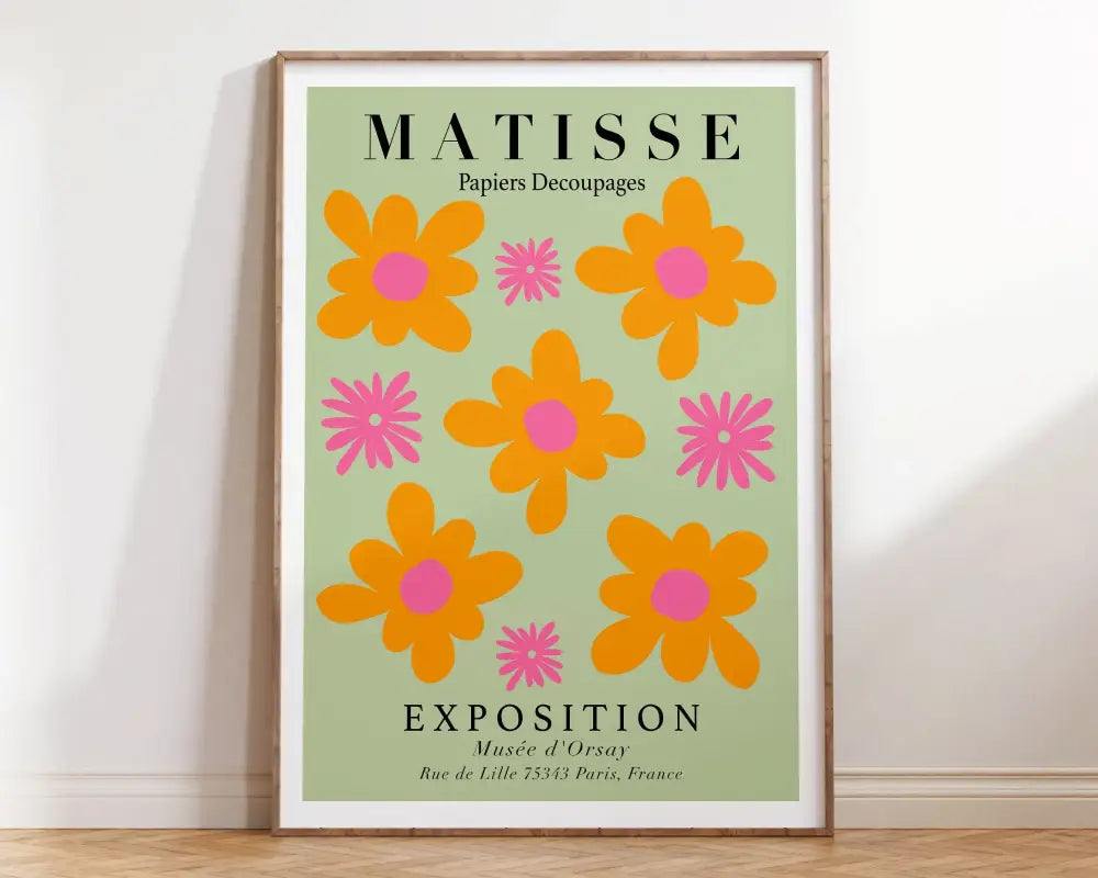 A framed decorbites matisse floral print featuring vibrant orange and pink flowers on a light green background