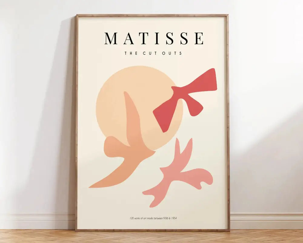 A minimalist framed poster from decorbites™ matisse floral prints collection with bold peach and coral silhouettes on cream background
