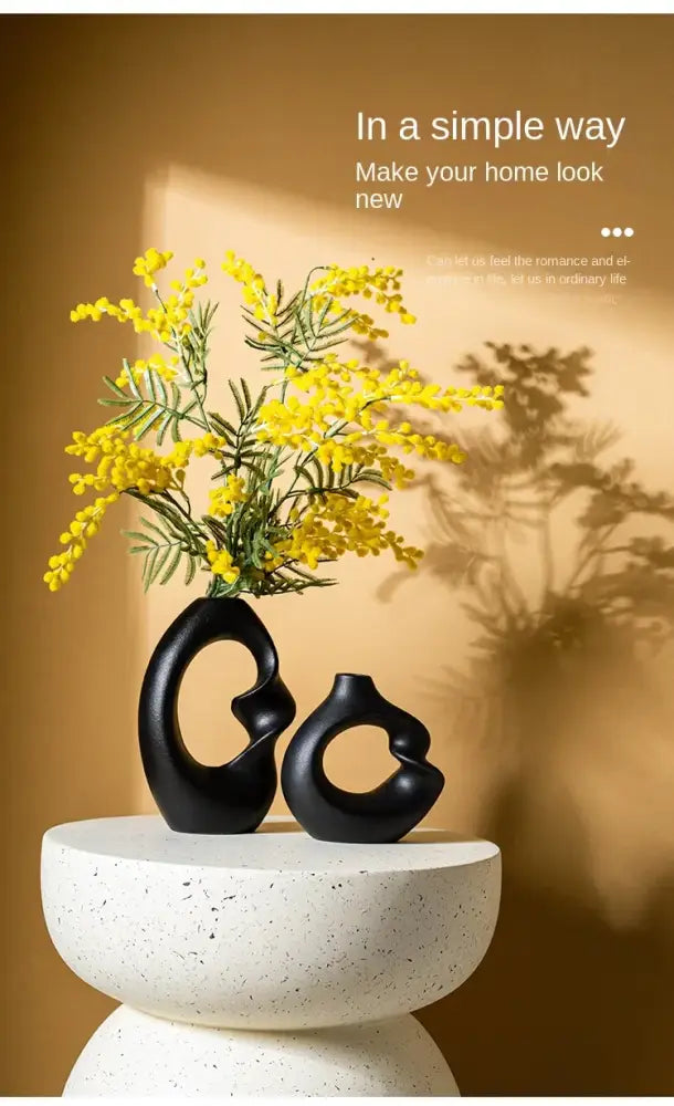 DecorBites matte black ceramic vase set features smooth flowing curves with yellow mimosa flowers for modern home decor
