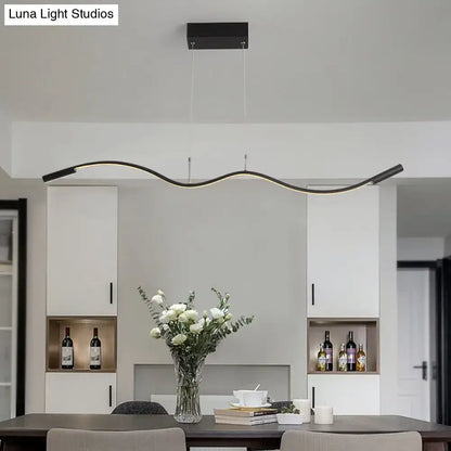 Modern black metal minimalist pendant light fixture with sleek curved design and integrated LED for dining room island