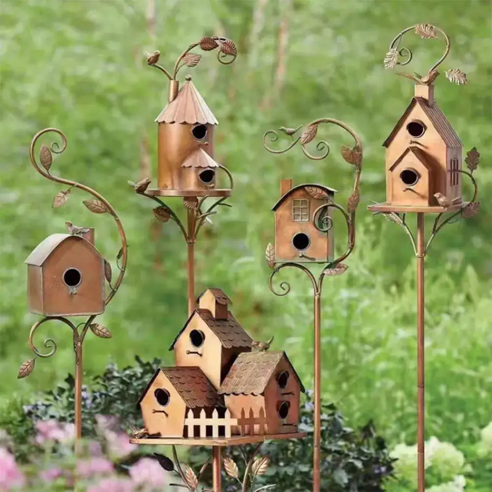 Copper-toned metal birdhouse garden stakes with ornate leafy scrollwork and varied cottage-style designs for outdoor decor