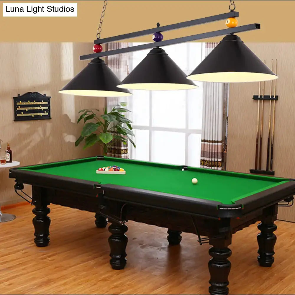 Black wrought iron pool table with green felt surface shown under decorbites metal hanging island light industrial pendant