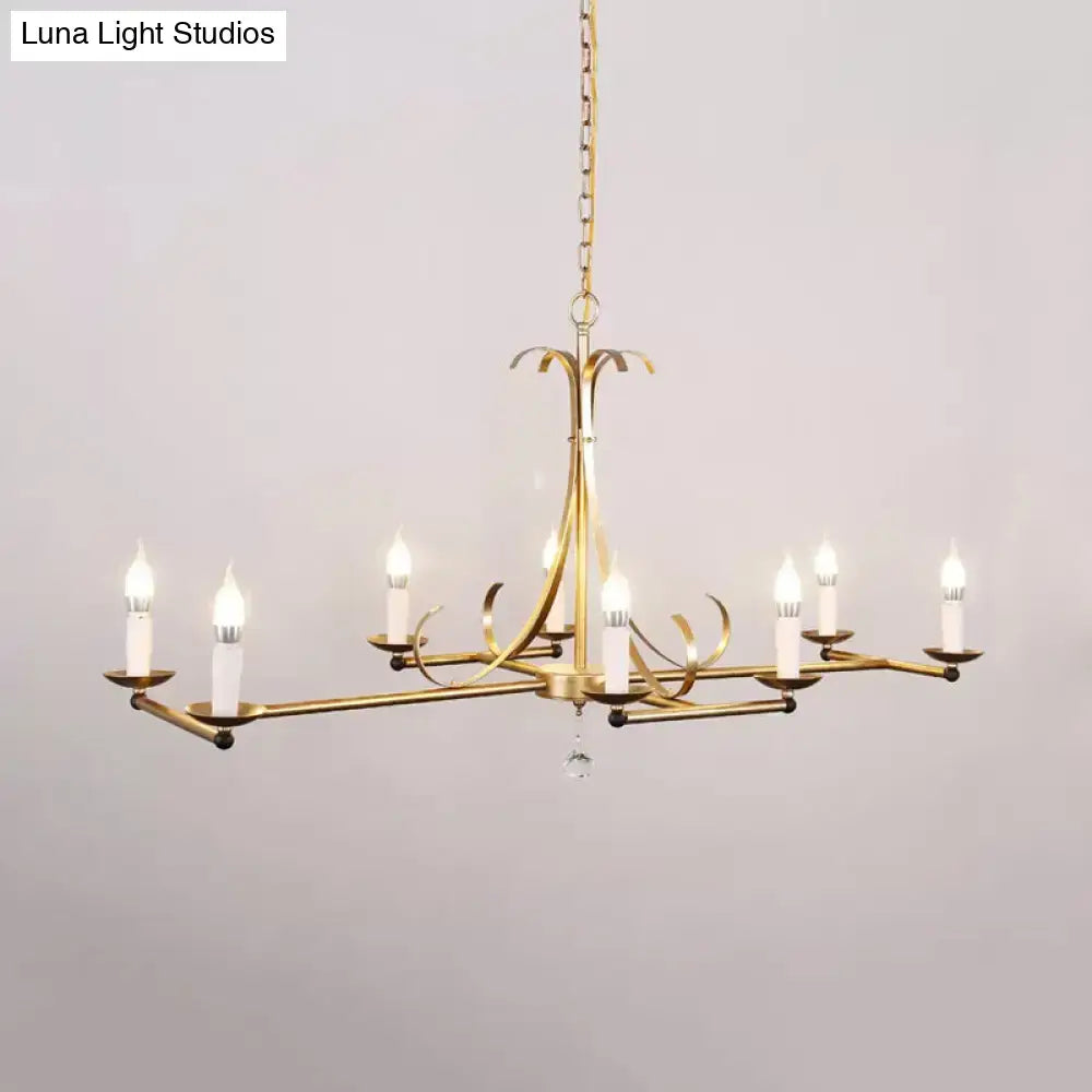 Gold-finished metal island chandelier light with six traditional candle bulbs and central crystal drop by DecorBites