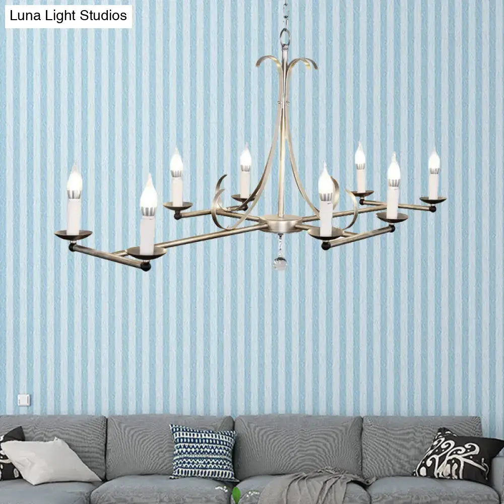 Antique brass metal island chandelier with ten traditional candle bulbs and a central crystal droplet