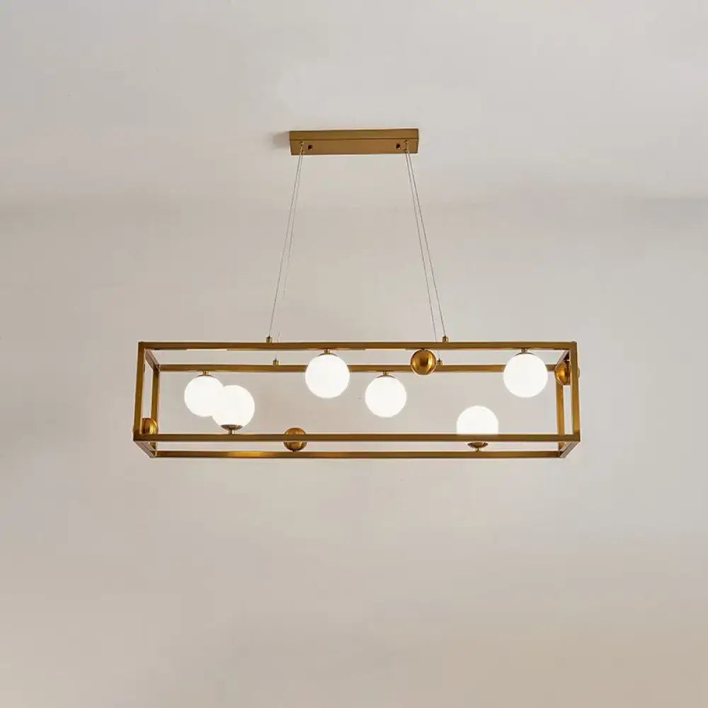 Gold-toned decorbites metal pendant light with geometric frame and milk glass shade for industrial dining rooms