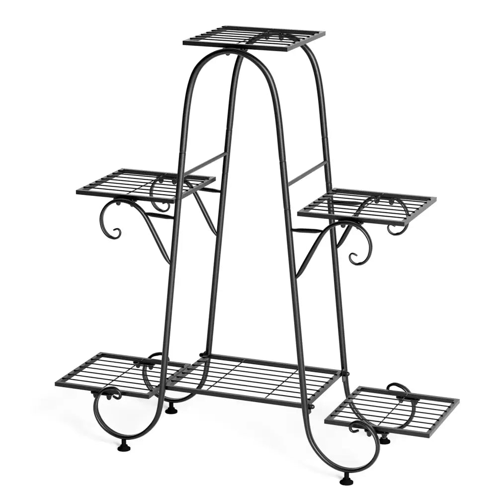 Black wrought iron metal plant stand with four tiered shelves and decorative scrollwork legs by decorbites